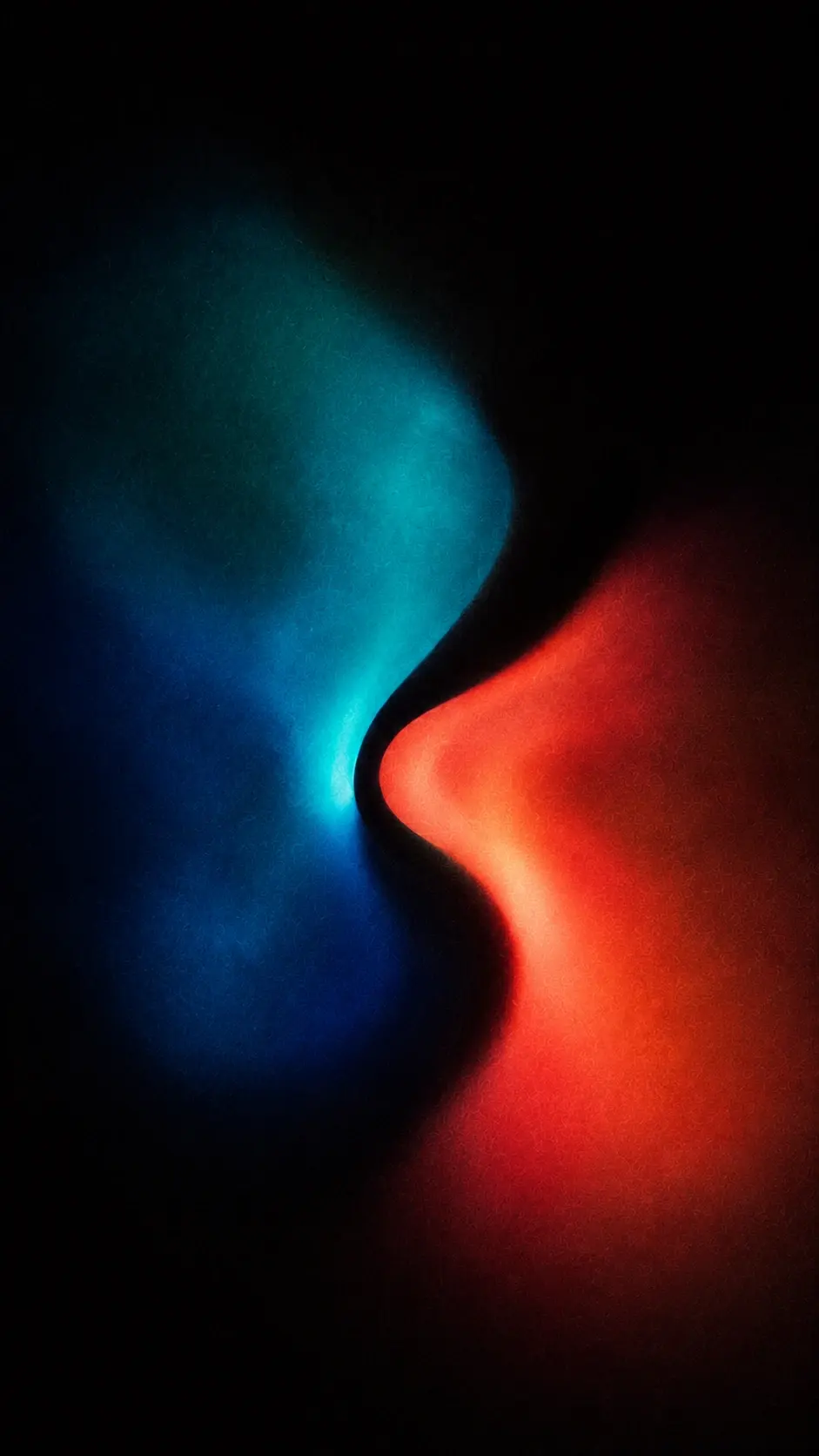 Experimental abstract gradient photograph, 9:16 portrait, black background, two large opposing organic forms interlock near the center without touching completely, one dominated by deep cyan, petrol blue and turquoise, the other by crimson, coral and burnt red, narrow black separation between them, soft swollen contours, diffuse luminous edges, colors bleeding subtly into surrounding darkness, fine gritty film grain, analog noise, soft atmospheric haze, sophisticated contemporary art aesthetic, no objects, no text