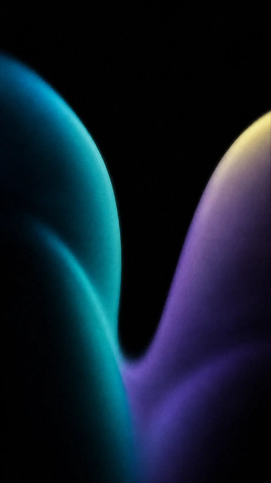 Abstract blurred gradient composition, 9:16 portrait, deep black background, two enormous translucent folds rise from the bottom and separate toward the upper frame, creating a narrow dark valley between them, one fold illuminated with deep teal and cyan, the other transitioning through violet into a faint pale yellow highlight, broad soft surfaces, no hard outlines, hazy atmospheric diffusion, subtle bloom, tactile analog grain, sophisticated dark editorial aesthetic, no literal fabric, no objects, no text