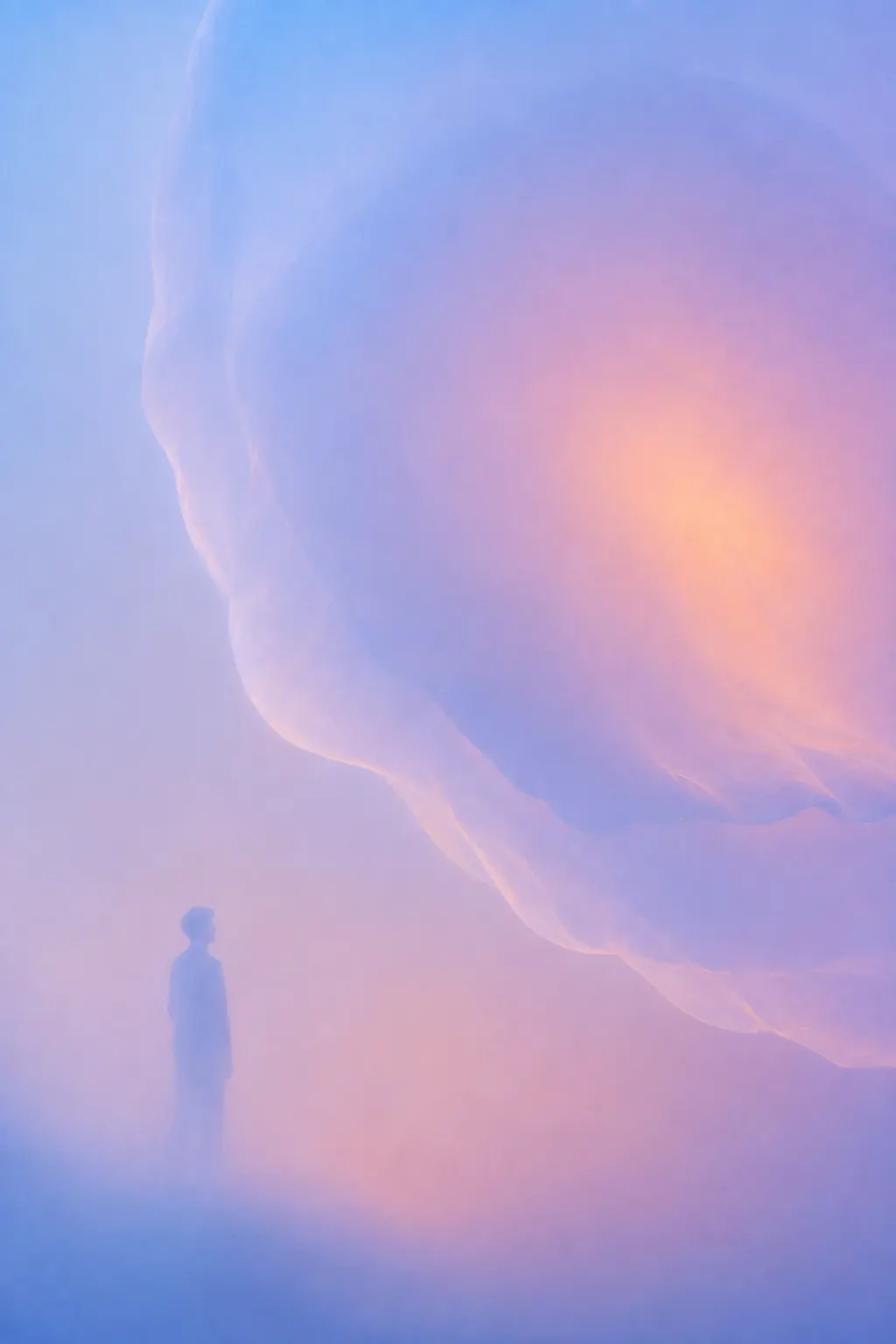 A large human silhouette occupying the lower-left corner, standing beneath an enormous soft translucent organic shape that fills the upper-right, the shape is pale blue with lavender edges and a warm peach-orange center, the person appears tiny against it, everything heavily diffused and almost dissolving into the background. STYLE LOCK